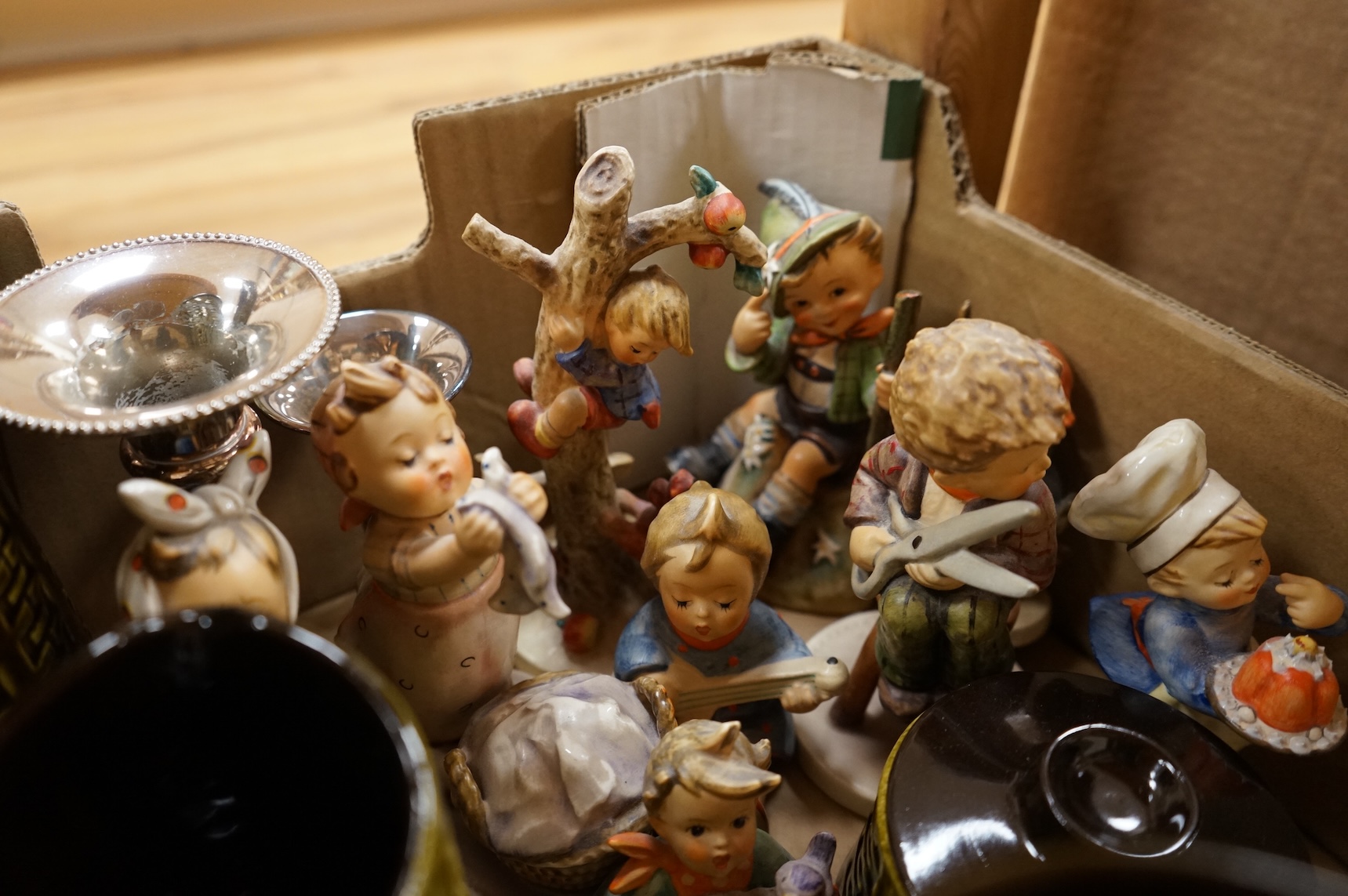 A collection of ceramics to include Doulton Toby jugs, Goebel figurines and Adderley part tea set